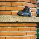 black leather work boots on gray concrete stairs