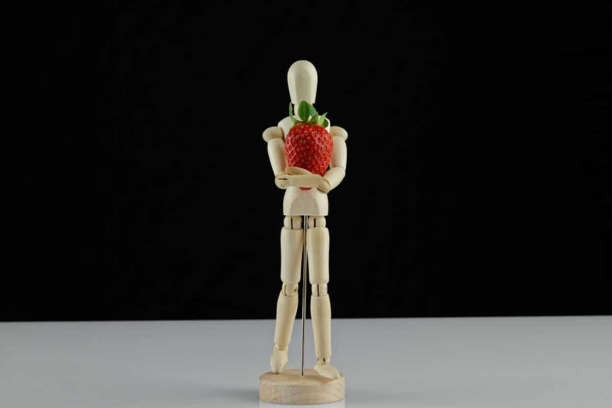 brown wooden figurine with red roses